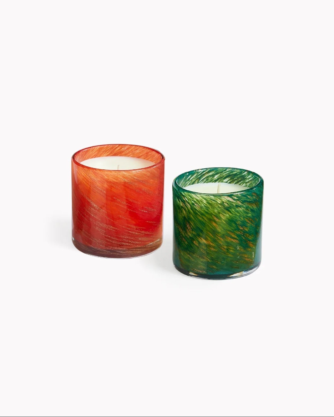 Two colorful glass candles on a white background, holiday scents