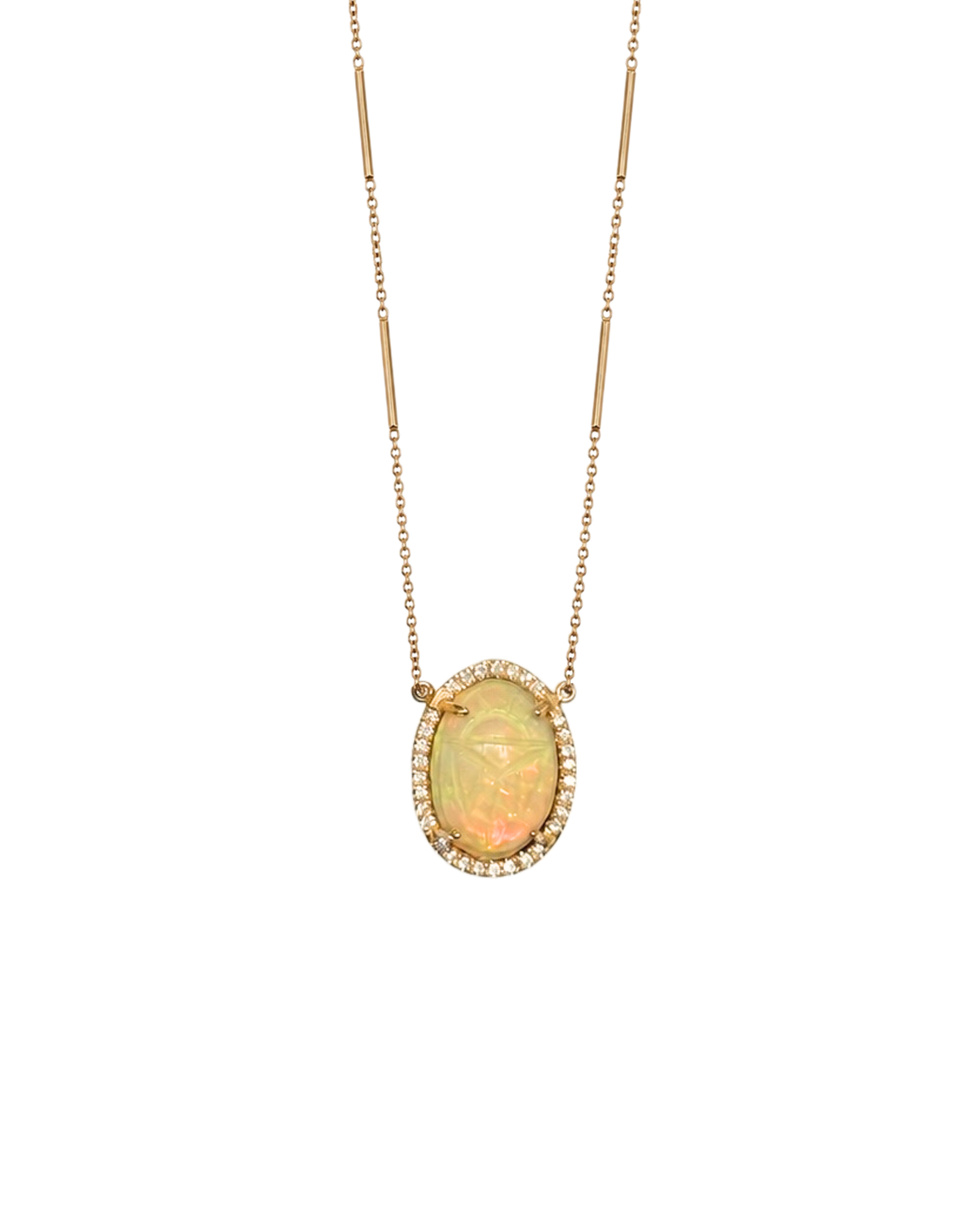 A gold necklace featuring an oval opal pendant with a halo of small clear stones, displayed against a solid white background.
