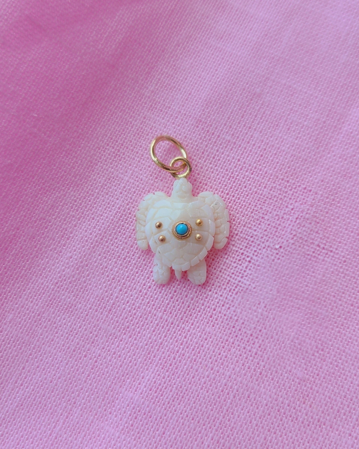 Small ivory sea turtle charm with a turquoise  gem